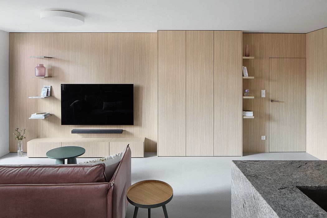 Minimalist living room with wooden paneled walls, TV unit, and built-in storage.