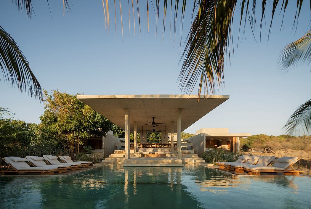 Luxurious poolside pavilion with modern architectural design and lush tropical surroundings.
