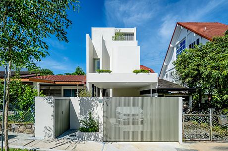 Striking white modern home with unique architectural features and landscaping.