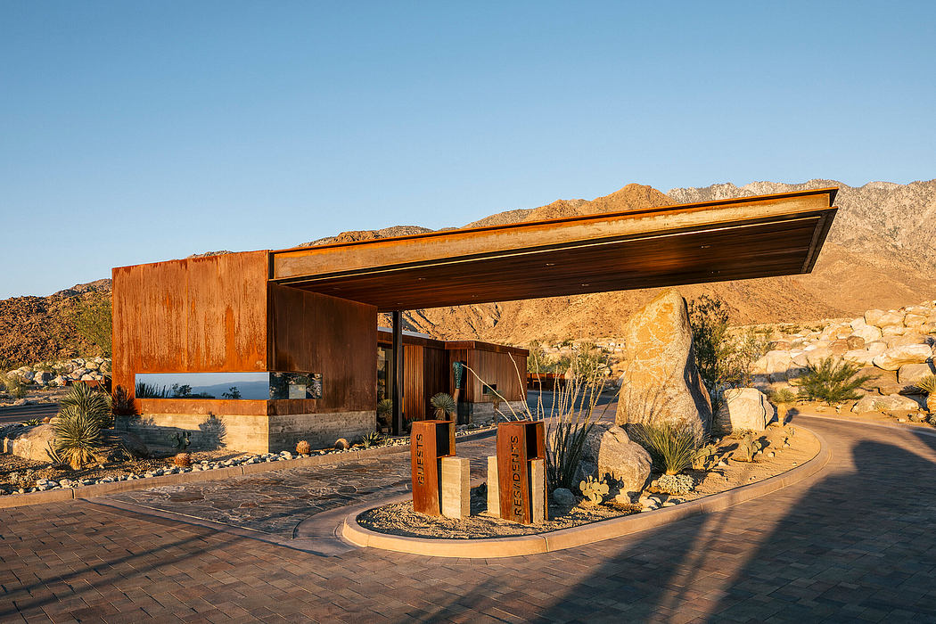 Modern desert architecture with wooden exterior, dramatic mountain backdrop.