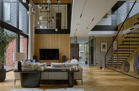 Spacious modern living room with wooden panels, hanging lamps, and a spiral staircase.