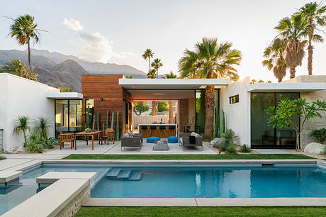 Modern desert home with pool, palm trees, and sophisticated outdoor living area.