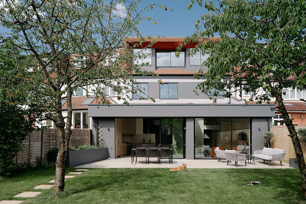 A modern two-story house with an open-plan layout, expansive glass windows, and a well-manicured garden.