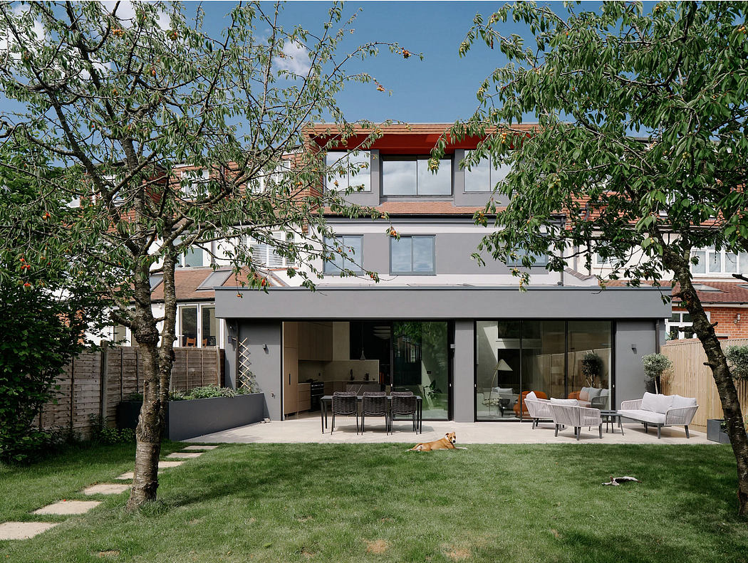 A modern two-story house with an open-plan layout, expansive glass windows, and a well-manicured garden.