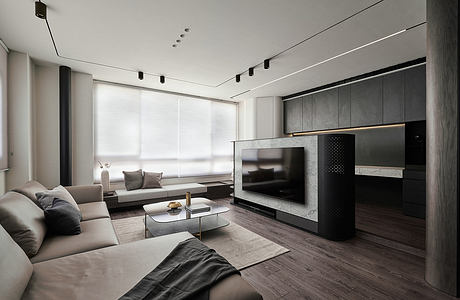 Modern living room with sleek gray furniture, minimalist TV console, and recessed lighting.
