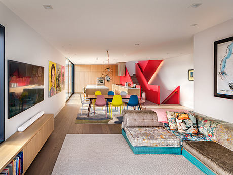 An open, modern living space with vibrant colors, geometric shapes, and abstract artwork.