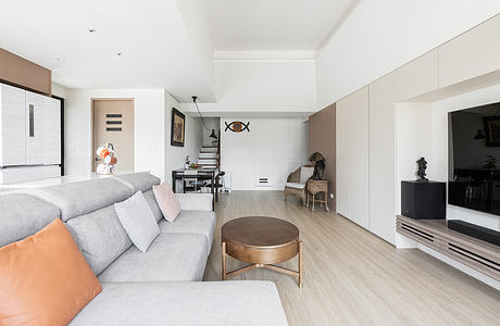 Bright, modern living room with neutral tones, geometric decor, and sleek furnishings.