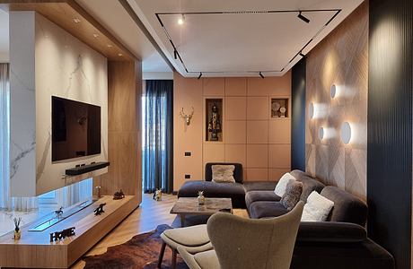 Sleek, modern living room with wood paneling, track lighting, and built-in TV cabinet.