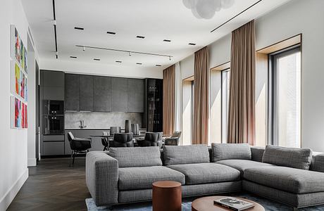 Sleek, modern living room with gray sectional, wood accents, and vibrant artwork.