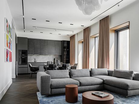 Sleek, modern living room with gray sectional, wood accents, and vibrant artwork.