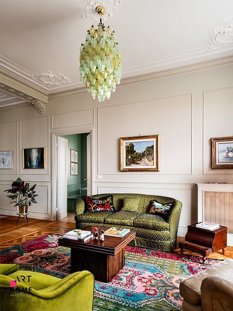 Ornate ceiling, patterned rug, colorful sofa, and framed artwork in elegant room.