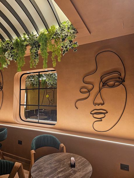 A cozy interior with stylized wall art, lush greenery, and modern furnishings.