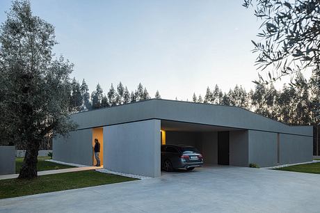 Modern minimalist carport with sleek, angular design and recessed lighting.