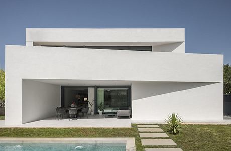 Sleek, minimalist architecture with clean lines, large windows, and an open-concept design.