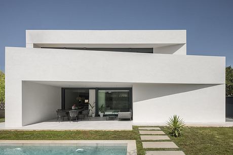 Sleek, minimalist architecture with clean lines, large windows, and an open-concept design.