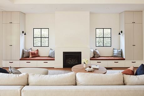 Cozy living room with plush seating, built-in cabinetry, and a central fireplace.