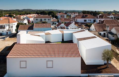 Charming village with traditional terracotta-tiled roofs and modern white architecture.