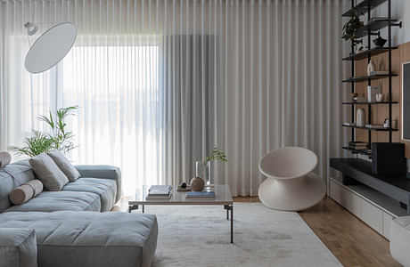 Modern living room with sleek furniture, minimalist shelving, and large windows providing ample natural light.