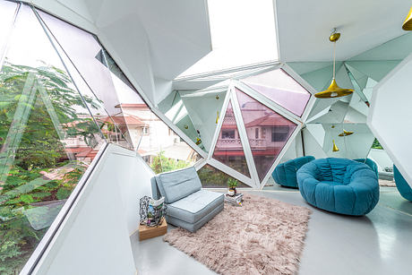 Futuristic living space with geometric glass walls, cozy seating, and lush greenery.