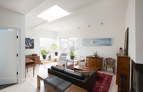 Bright, open living space with natural light, mixed vintage and modern furnishings.