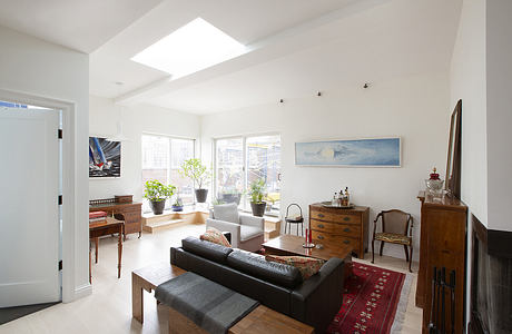 Bright, open living space with natural light, mixed vintage and modern furnishings.