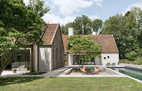 Contemporary home design with wood-shingled roof, glass walls, and sleek poolside features.