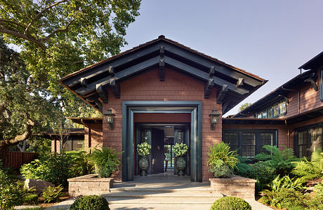 Rustic wood-and-stone exterior with decorative trim, inviting front entrance.