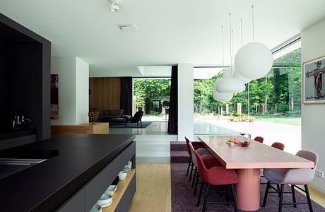 Minimalist open-plan interior design with sleek kitchen, dining area, and living room.