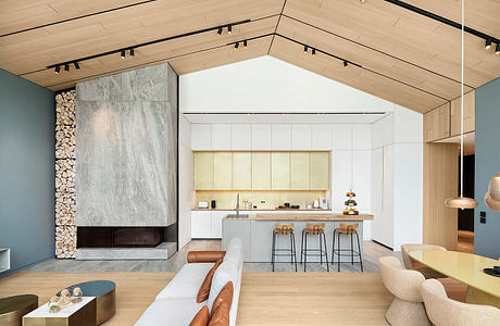 Spacious open-concept kitchen with wooden beams, modern fireplace, and minimalist decor.