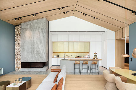 Spacious open-concept kitchen with wooden beams, modern fireplace, and minimalist decor.