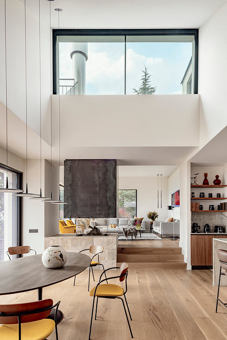A bright, airy living space with modern furniture, high ceilings, and floor-to-ceiling windows.
