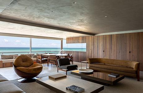 Stunning modern interior with panoramic ocean views, wood paneling, and plush seating.