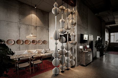 Striking pendant lights, textured walls, and cozy seating in a modern, industrial setting.