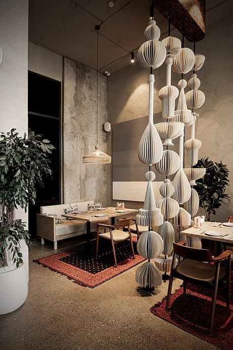 Striking architectural details with intricate paper lanterns in a contemporary cafe setting.