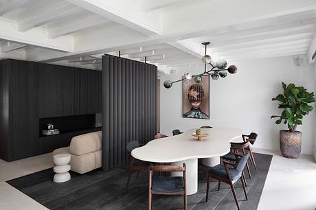 Elegant open-concept living area with modern furnishings, lighting fixtures, and partition wall.