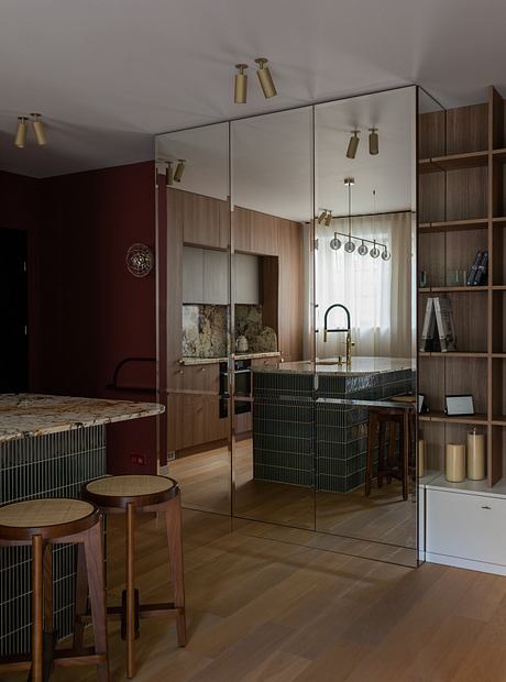 Sleek modern kitchen with wooden cabinetry, metal accents, and glass partition.
