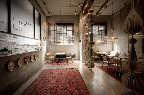 A cozy, rustic-chic cafe with wooden furnishings, patterned rugs, and eye-catching pendant lights.