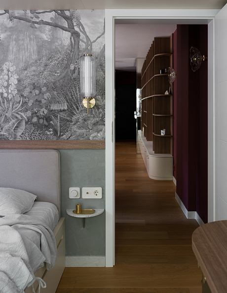 A cozy and stylish bedroom with a large mural, minimalist furniture, and warm lighting.