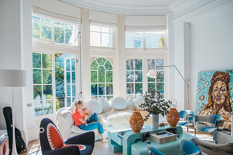 Elegant, light-filled living room with arched windows and cozy seating arrangements.