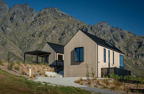 Striking modern mountain retreat with distinctive gabled roofs and clean lines.