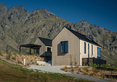 Striking modern mountain retreat with distinctive gabled roofs and clean lines.