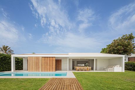 Contemporary single-story home with minimalist design, wooden accents, and outdoor pool.