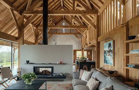 Rustic wooden beams and walls create a warm, cozy atmosphere in this modern living space.