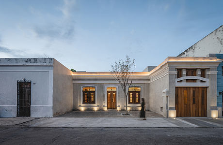 A beautifully restored colonial-style building with intricate arched windows and a central courtyard.