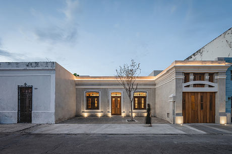 A beautifully restored colonial-style building with intricate arched windows and a central courtyard.