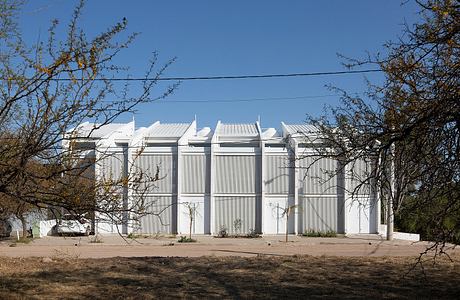 White modernist building with bold architectural facade and minimal details.