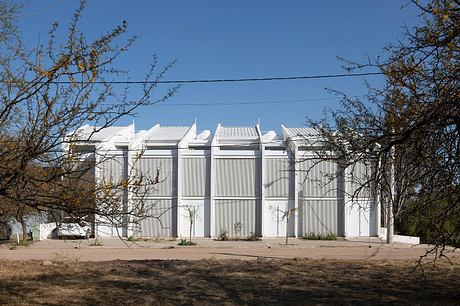 White modernist building with bold architectural facade and minimal details.