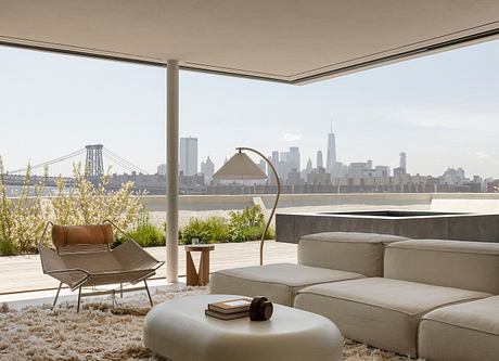 Stunning modern patio with sleek furniture, lush greenery, and a breathtaking skyline view.