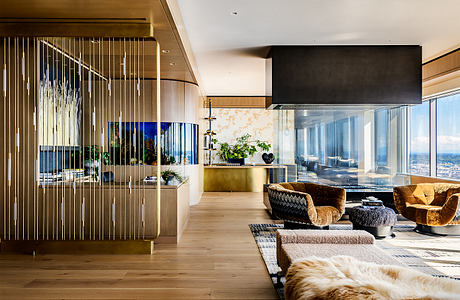 Stunning modern interior with sleek glass walls, warm wood tones, and plush furnishings.