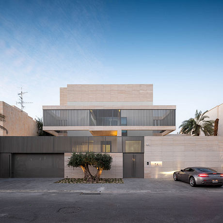 Modern, minimalist building with a striking contrast between light facade and dark accents.